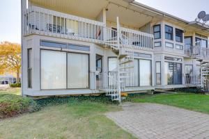 a house with balconies on the side of it at Pet-Friendly Oak Harbor Condo Walk to Lake! in Sand Beach