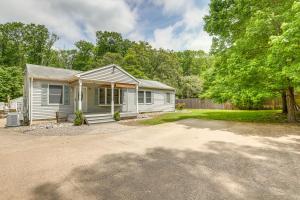 a small white house with a tree and a driveway at Pet-Friendly New Egypt Home with Fenced Pool and Grill in Cookstown