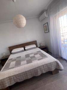 a bedroom with a bed with a checkered blanket at Lo Pagan Beachfront Aircon Apartment in San Pedro del Pinatar