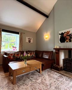 a living room with a couch and a table at Swallow Cottage in Ripon