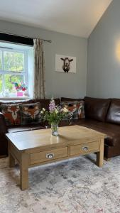 a living room with a couch and a coffee table at Swallow Cottage in Ripon