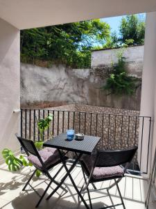 a black table and two chairs on a balcony at Apartman Emily2 Dramalj in Dramalj