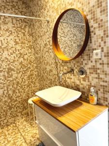 La salle de bains est pourvue d'un lavabo et d'un miroir. dans l'établissement Alto da Barra *Ocean View, à Oeiras