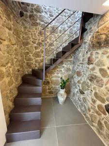 a staircase in a stone wall with a potted plant at CRYSAS HOME in Assoro +87 photos