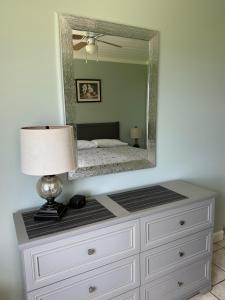 a dresser with a mirror on top of it at Ocean Front Paradise Resort in Melbourne