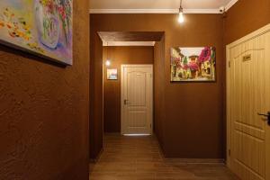 a hallway with a white door and a painting on the wall at Готель Кайзер у Львові in Lviv