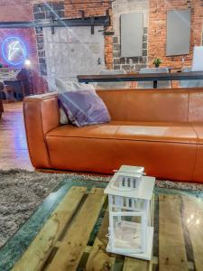 a couch in a living room with a table at Stylish Philly Loft in Philadelphia +35 photos