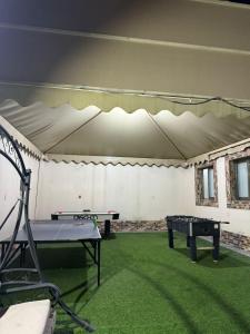 a ping pong room with a ping pong table at استراحات توليب أبها in Qāʼid