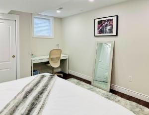 a bedroom with a bed and a desk and a mirror at Spacious 2 Bedroom 1 bath Mississauga Basement Apartment in Mississauga
