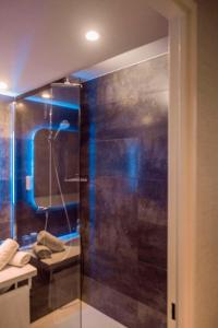 a bathroom with a shower with a toilet and a sink at Best Western Allegro Nation in Paris