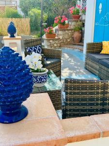 a patio with a table with blue vases on it at Capri Joy in Capri
