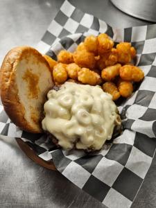a plate of food with a sandwich and tater tots at Lewiston Hotel Bar & Grill in Lewiston