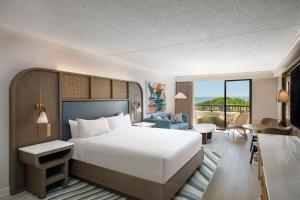 a bedroom with a bed and a living room at Sonesta Resort Hilton Head Island in Hilton Head Island