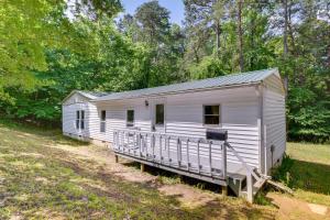 a small white cabin in the middle of a field at Single-Story Cabin on Hyco Lake Swim and Unwind! in Semora