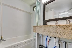 a bathroom with a sink and a bath tub at Single-Story Cabin on Hyco Lake Swim and Unwind! in Semora +15 photos