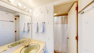 a bathroom with a sink and a mirror at Ocean Breeze Retreat in North Truro