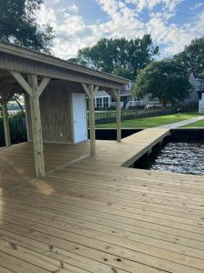 a wooden dock with a building on the water at Luxury Lakefront property in Milledgeville