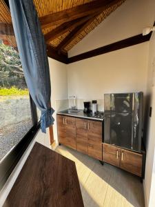 a kitchen with a stove and a counter top at Cabañas Villa Celeste in Villa de Leyva