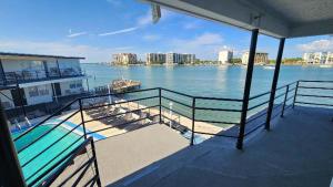 a balcony of a boat with a view of the water at By the Beach Rentals in Clearwater Beach
