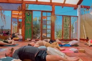 a group of people laying on the floor in a yoga class at Teepee Barranco in Tindaya