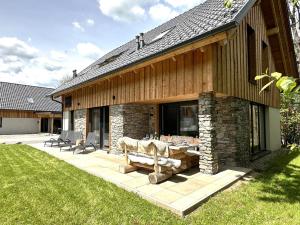 a house with a bench on a patio at Mountain Chalet Luxx in Sankt Lorenzen ob Murau
