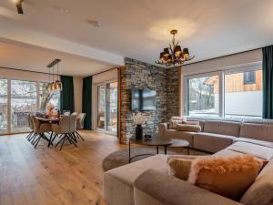 a living room with a couch and a table at Mountain Chalet Luxx in Sankt Lorenzen ob Murau