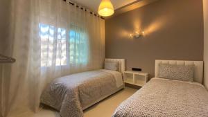 Posteľ alebo postele v izbe v ubytovaní RABAT RESIDENCE - Apartments