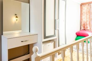 a white staircase with a mirror and a stool at The Wall Private Mansion Kumkapı in Istanbul