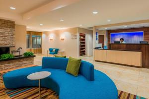 a living room with a blue couch in a lobby at Fairfield Inn and Suites Mobile in Mobile