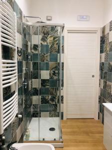 a shower with a glass door in a bathroom at Green House GM in Gragnano