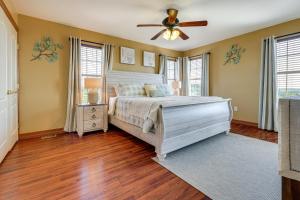 a bedroom with a bed and a ceiling fan at Family-Friendly Fischer Home with Private Hot Tub! in Fischer