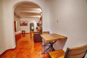 a dining room with a table and a living room at Hotel Casa Tequis San Luis Potosi in San Luis Potosí