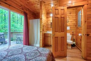 a bedroom with a bed in a wooden cabin at Blue Rose Cabins - Cupids Cabin in Logan