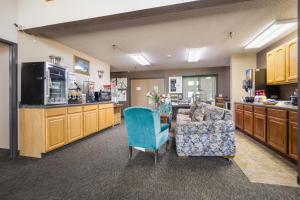 a living room with a couch and a kitchen at De Smet Super Deluxe Inn & suites in De Smet