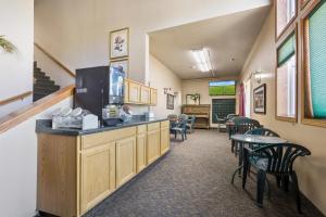 a waiting room with a counter and tables and chairs at De Smet Super Deluxe Inn & suites in De Smet