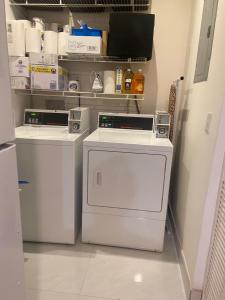 a laundry room with two washer and dryer at small room with sharing bathroom in Boca Raton