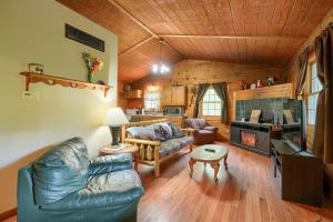 a living room with a couch and a table at Blue Rose Cabins - Lincoln Log Cabin in Logan