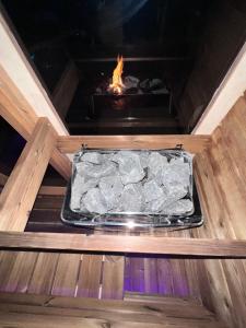 a tray of rocks in a fire oven at Maison spa sauna in Morangis