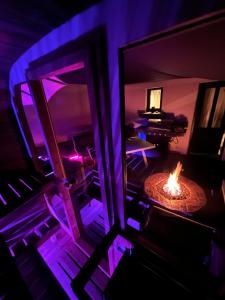 an overhead view of a living room with a fire in a table at Maison spa sauna in Morangis