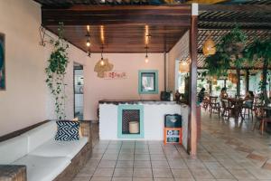 a restaurant with a fireplace in the middle of a room at Pousada Sossego in Pipa