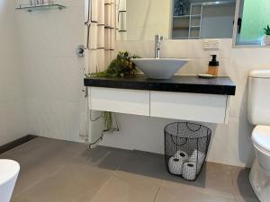 a bathroom with a sink and a toilet at Peppertree lodge in Havelock North