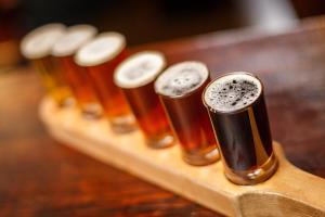 a row of beer bottles on a wooden board at Kings Head Holt in Holt