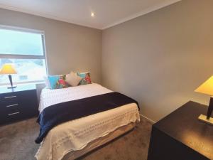 a bedroom with a bed and a window at Oxleys 501 3 Bedroom Penthouse in Picton +13 photos