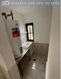 a small bathroom with a sink and a counter at Cabaña Alpina del Centro in Chilecito