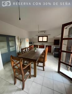 a dining room with a wooden table and chairs at Cabaña Alpina del Centro in Chilecito +9 photos