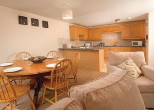 a kitchen and dining room with a table and chairs at Kenegie Manor in Gulval