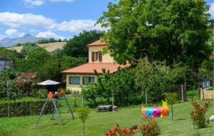 a yard with a house in the background with a playground at Awesome Home In Montefalcone Appennino in Montefalcone Appennino +37 photos