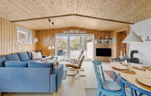a living room with a blue couch and a table at Gorgeous Home In Thisted With Wifi in Thisted
