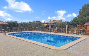 een zwembad voor een hek bij Lovely Home In Pozo De Los Palos With Kitchen 