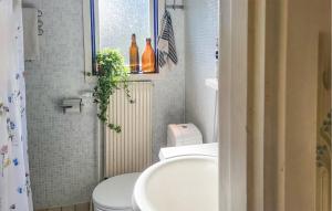a small bathroom with a toilet and a sink at Stunning Home In Leksand With Kitchen in Leksand